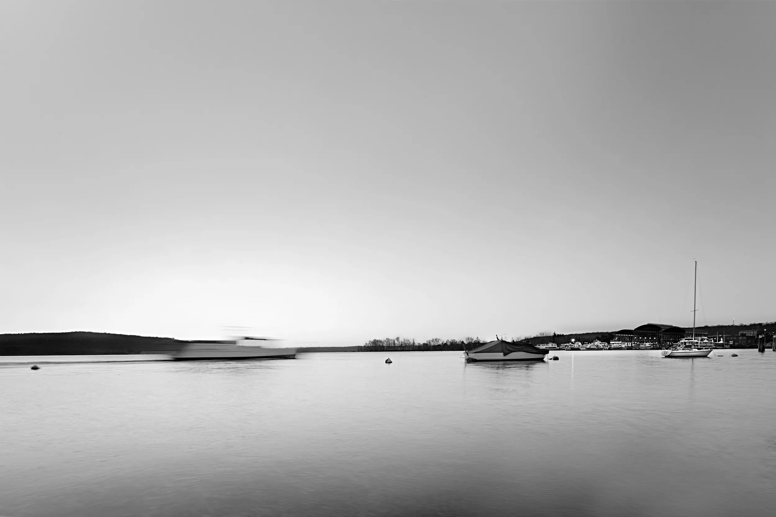 Still lake mirroring the surrounding landscape at dusk